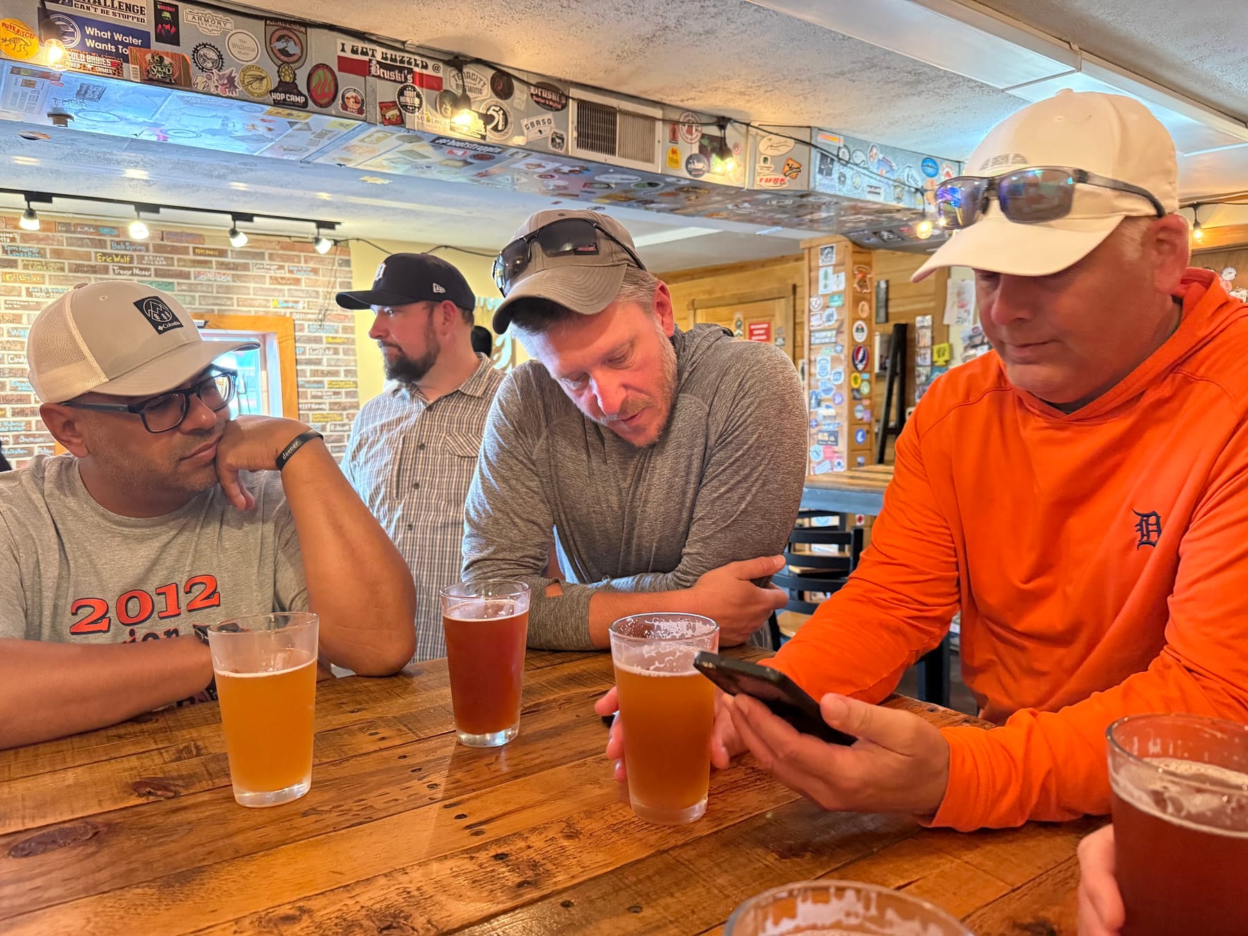 Kings with pints at a brewery bar