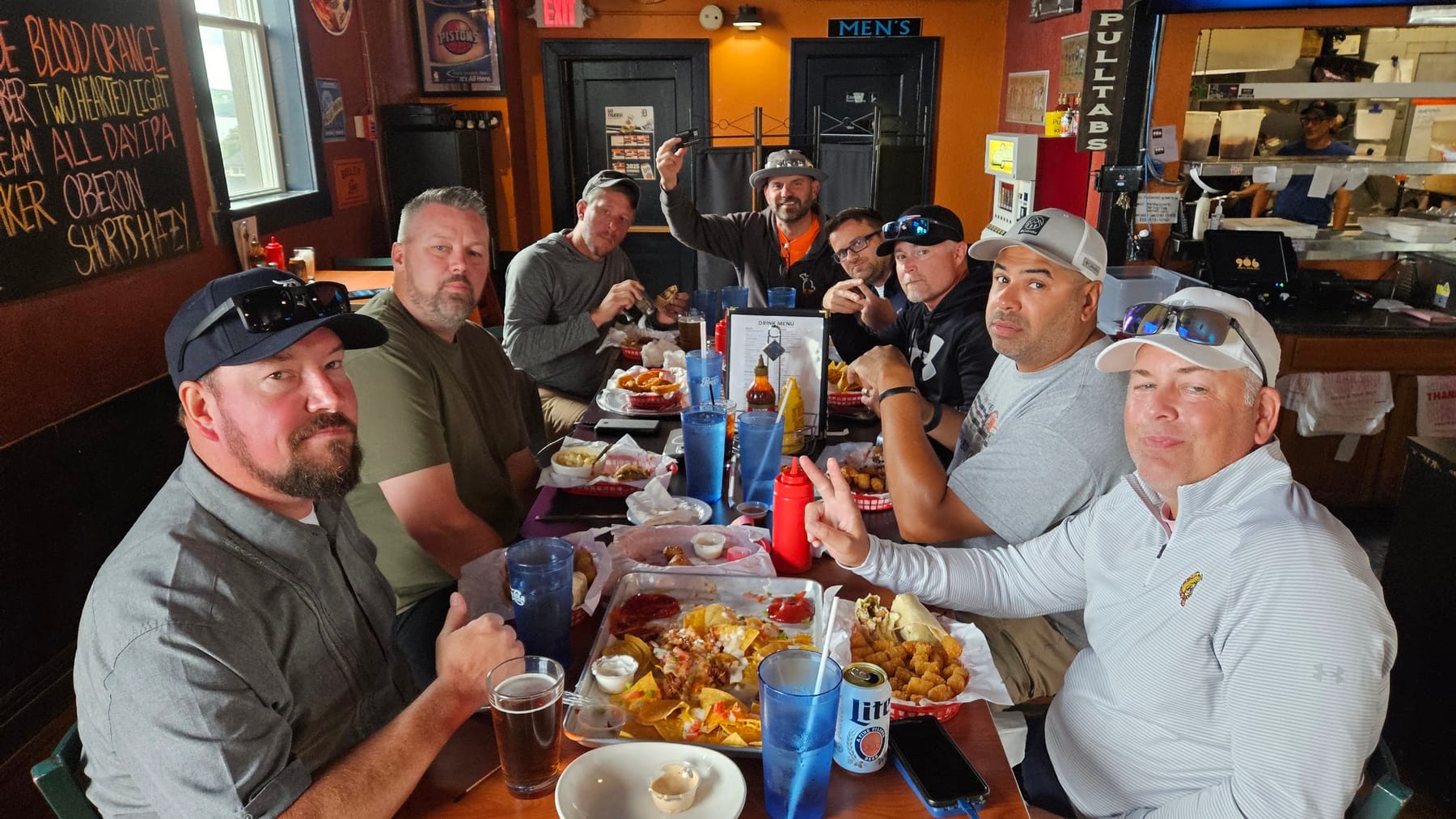 The Kings around a table of wings and fries